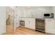 This bar area features white cabinetry, marble countertop, a wine fridge, and a dishwasher at 1665 Sterling Rd, Charlotte, NC 28209