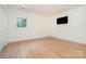 A bright and airy bedroom with hardwood floors, recessed lighting, and a large window at 1665 Sterling Rd, Charlotte, NC 28209
