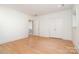 Spacious bedroom with light hardwood floors, a double closet, and bright neutral paint at 1665 Sterling Rd, Charlotte, NC 28209