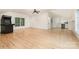 Bright bonus room with hardwood floors, a ceiling fan, and a bar area at 1665 Sterling Rd, Charlotte, NC 28209
