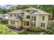 Stately home boasts a turret, manicured landscaping, and inviting column-supported front entryway at 1665 Sterling Rd, Charlotte, NC 28209