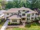Aerial view of a stunning cream-colored home with a beautiful roof and lush landscaping, offering great curb appeal at 1665 Sterling Rd, Charlotte, NC 28209