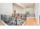 View of the home's foyer showcasing high ceilings, hardwood floors, and decorative wrought iron railing at 1665 Sterling Rd, Charlotte, NC 28209