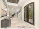 Elegant foyer with wrought iron double doors, grand staircase, marble flooring, and designer console table at 1665 Sterling Rd, Charlotte, NC 28209