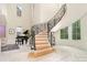 Elegant foyer features a curved staircase with ornamental ironwork and gleaming marble floors, creating a grand entrance at 1665 Sterling Rd, Charlotte, NC 28209