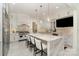 Bright kitchen features an oversized marble island, stainless steel appliances, and custom white cabinets at 1665 Sterling Rd, Charlotte, NC 28209