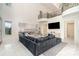 Elegant living area featuring a stone fireplace, comfortable sectional seating, and an open view of the upper-level balcony at 1665 Sterling Rd, Charlotte, NC 28209