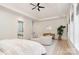 Spacious main bedroom with seating area, hardwood floors, tray ceilings and modern decor at 1665 Sterling Rd, Charlotte, NC 28209
