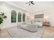 Bright main bedroom with sitting area, tray ceilings, hardwood floors and natural light at 1665 Sterling Rd, Charlotte, NC 28209
