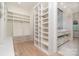 Spacious walk-in closet with custom shelving, drawers and bathroom with double sink and vanity at 1665 Sterling Rd, Charlotte, NC 28209