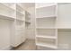 Spacious walk-in closet features built-in shelves, drawers, and a patterned carpet at 1665 Sterling Rd, Charlotte, NC 28209