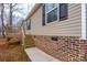 Home with a brick foundation, beige siding, wooden porch, and a sidewalk at 1795 Kestrel Valley Ln, Catawba, NC 28609