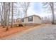 Charming home with beige siding, black shutters, and inviting wooden front porch at 1795 Kestrel Valley Ln, Catawba, NC 28609