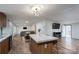 Open concept kitchen area with wood cabinets and an island flowing into the living spaces at 1795 Kestrel Valley Ln, Catawba, NC 28609
