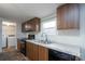 Well-lit kitchen features wood cabinets, modern appliances, and a stainless steel sink at 1795 Kestrel Valley Ln, Catawba, NC 28609