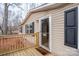 Exterior view of a beige home with black shutters and a cozy covered front porch at 1795 Kestrel Valley Ln, Catawba, NC 28609