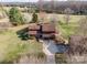 Aerial view of home showcasing large lot, mature trees, and detached garage at 190 Country Dr, Statesville, NC 28625