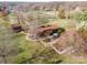 Aerial view of a large estate featuring a landscaped backyard, patio, and mature trees at 190 Country Dr, Statesville, NC 28625
