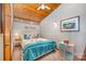 Well-lit bedroom featuring a wood-paneled ceiling, comfortable bed, and charming decor for a cozy ambiance at 190 Country Dr, Statesville, NC 28625