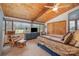 Bright bedroom showcasing a vaulted wood ceiling, cozy chair, and a dresser with a television for added convenience at 190 Country Dr, Statesville, NC 28625