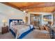 Bedroom boasts a wood-paneled ceiling, a ceiling fan, a comfortable chair, and a glass door leading to an outdoor patio at 190 Country Dr, Statesville, NC 28625