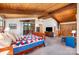 Spacious bedroom featuring a wood-paneled ceiling, large windows, and a comfortable bed with a colorful quilt at 190 Country Dr, Statesville, NC 28625