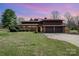 A brick home with a large front yard and an attached three car garage under a pink and purple sky at 190 Country Dr, Statesville, NC 28625