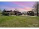 Exterior of home with well-maintained lawn and detached garage/guest house at 190 Country Dr, Statesville, NC 28625