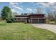 A brick home with a large front yard and an attached three car garage under a blue sky at 190 Country Dr, Statesville, NC 28625