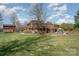 Spacious home with expansive yard, outbuilding, and a brick patio perfect for entertaining at 190 Country Dr, Statesville, NC 28625