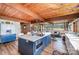Open concept kitchen boasts a large blue island with bar seating, and wood ceiling at 190 Country Dr, Statesville, NC 28625