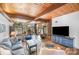 Bright living room with wood floors, wood ceilings, fireplace, and views to the backyard at 190 Country Dr, Statesville, NC 28625
