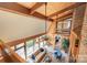 Open floorplan living room boasts wood ceiling beams, large windows, and ample natural light at 190 Country Dr, Statesville, NC 28625
