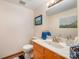 Cozy powder room features a marble countertop, framed mirror, and decor at 190 Country Dr, Statesville, NC 28625