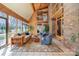 Light-filled sunroom with wood paneling, large windows, and comfortable seating with access to balcony at 190 Country Dr, Statesville, NC 28625