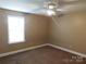 Cozy bedroom with neutral paint, carpet, and a ceiling fan at 1909 E Lawyers Rd, Monroe, NC 28110
