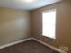 Neutral bedroom featuring carpeted floors and a bright window providing natural light at 1909 E Lawyers Rd, Monroe, NC 28110