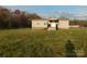 Charming single story home featuring a small porch, traditional windows, and vinyl siding at 1909 E Lawyers Rd, Monroe, NC 28110