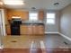 Functional kitchen featuring black appliances, wood cabinets, and tile flooring at 1909 E Lawyers Rd, Monroe, NC 28110
