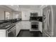 Bright kitchen featuring stainless steel appliances, dark countertops, and modern finishes at 2445 Selwyn Ave, Charlotte, NC 28209