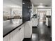 An open kitchen and dining area with black countertop, and dark wood floor at 2445 Selwyn Ave, Charlotte, NC 28209