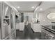 Modern kitchen featuring stainless steel appliances, sleek black countertops, and dark hardwood floors at 2445 Selwyn Ave, Charlotte, NC 28209