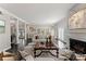Bright living room featuring a fireplace, dark floors, and lots of natural light at 2445 Selwyn Ave, Charlotte, NC 28209