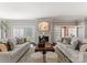 Cozy living room with matching sofas, fireplace, and shuttered windows creating a tranquil and inviting atmosphere at 2445 Selwyn Ave, Charlotte, NC 28209