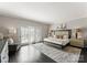 A primary bedroom featuring a large bed, neutral tones, stylish lamps, and a cozy rug at 2445 Selwyn Ave, Charlotte, NC 28209