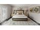 A serene primary bedroom featuring a large bed, neutral tones, stylish lamps, and a cozy rug at 2445 Selwyn Ave, Charlotte, NC 28209