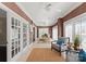 Bright home office with tile floors, French doors, and neutral accents creating a functional and stylish workspace at 2445 Selwyn Ave, Charlotte, NC 28209