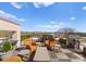 Wide angle shot of rooftop deck featuring stylish chairs, grill, tables and views of surrounding area at 2445 Selwyn Ave, Charlotte, NC 28209