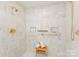 Bright marble walk-in shower complete with gold hardware and shampoo and soap niches at 2445 Selwyn Ave, Charlotte, NC 28209