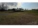 Spacious backyard featuring covered parking, a small storage shed, and a large grassy area at 2730 Medlin Rd, Monroe, NC 28112
